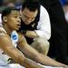 A Michigan trainer tends to sophomore Trey Burke after being injured in the game against South Dakota State on Thursday, March 21. Daniel Brenner I AnnArbor.com